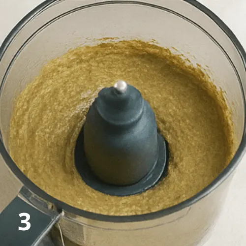 Blending pistachios and white chocolate in a food processor to make pistachio cream.